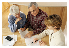 Home alarm company rep and customers reviewing paperwork